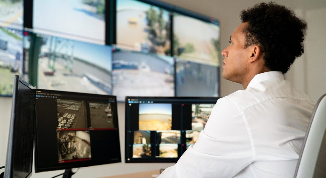 A Man Monitoring Security Cameras