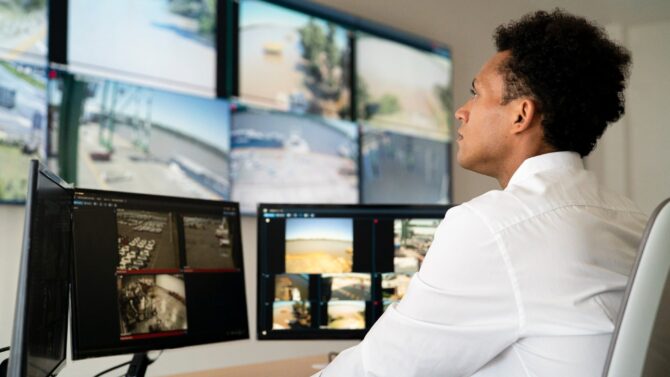 A Man Monitoring Security Cameras