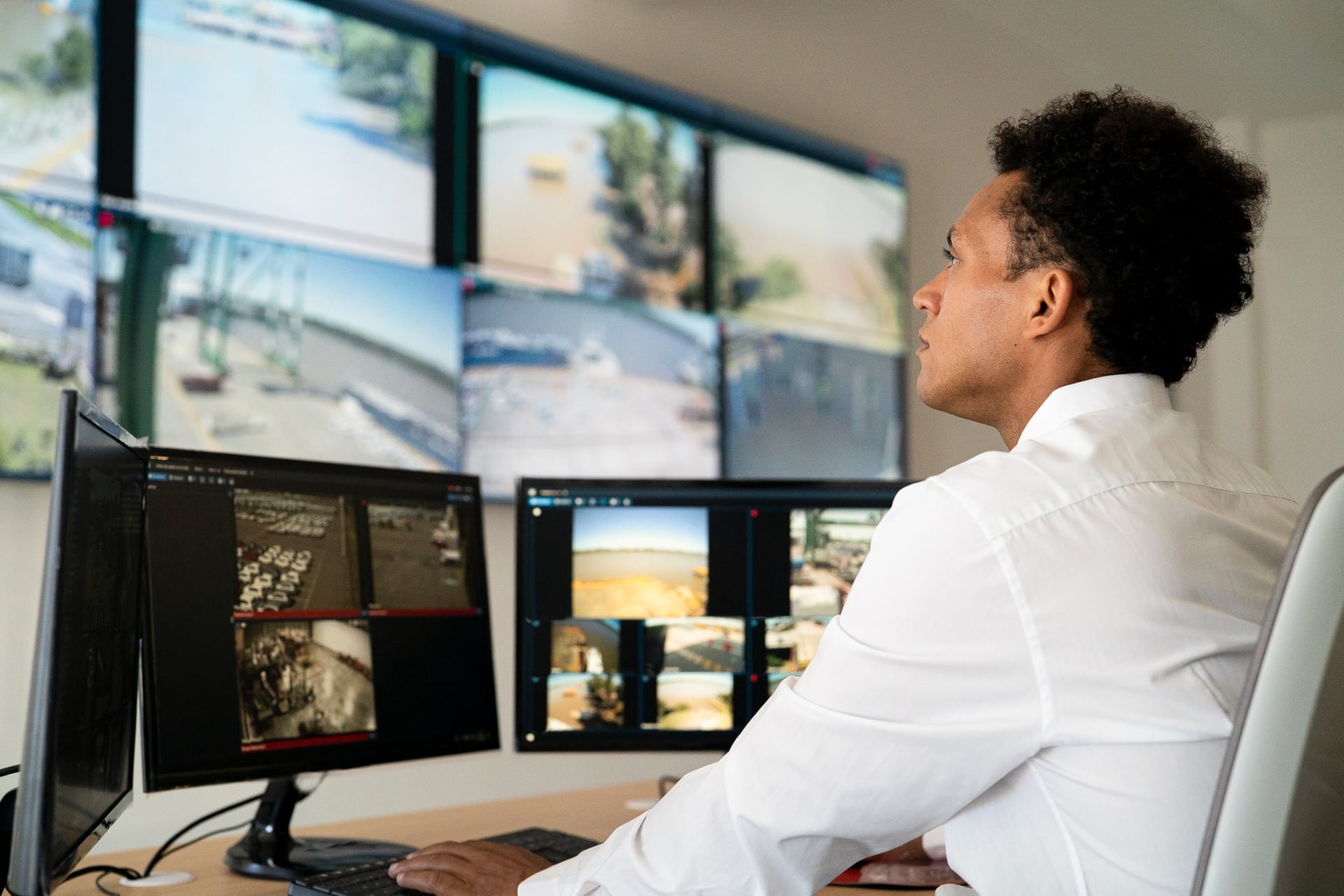 A man monitoring security cameras